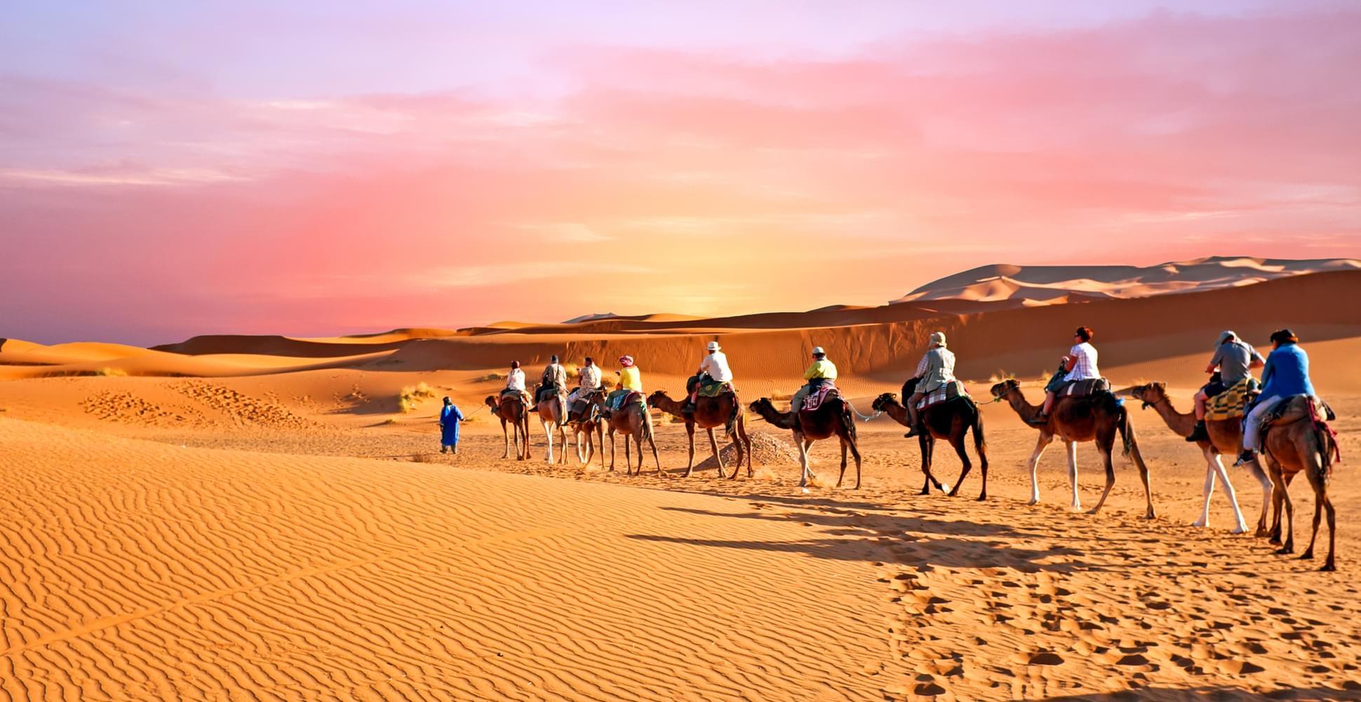 walking through the Sahara desert sand dunes in Morocco